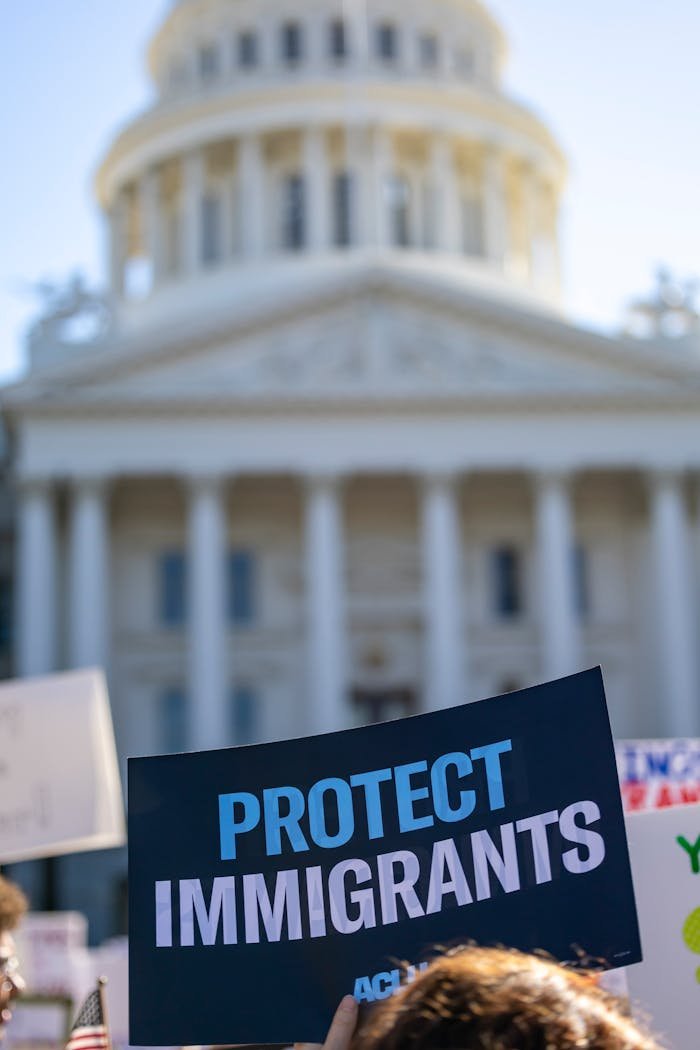 Sign reading Protect Immigrants seen at a protest in front of the California State Capitol in Sacramento.